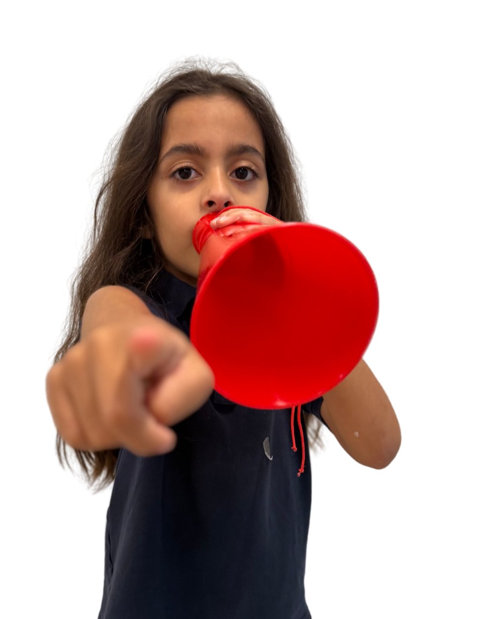 A young director at film camp for ages 7–12 pointing and calling action through a red megaphone