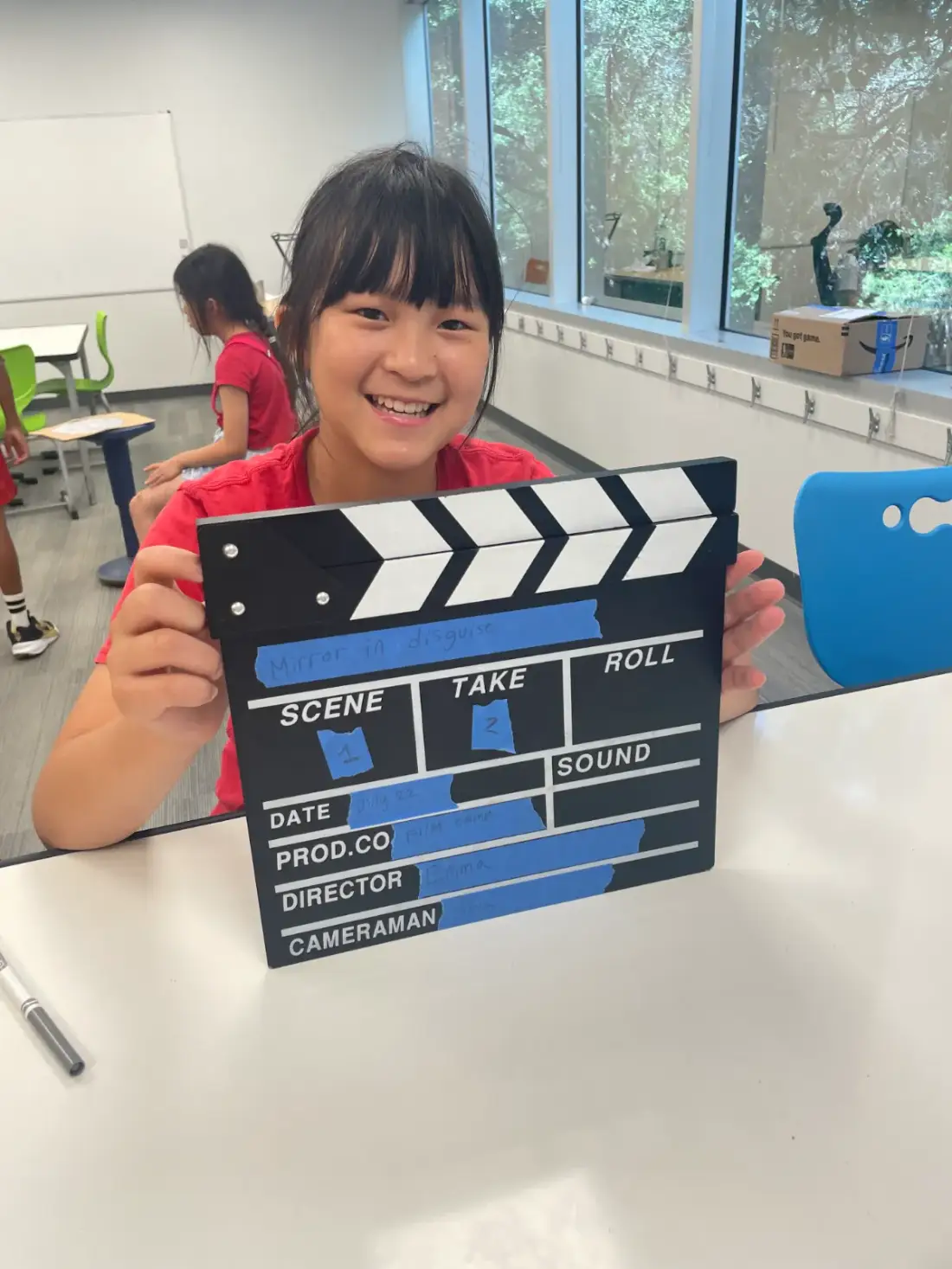 A camper holding the slate for her film