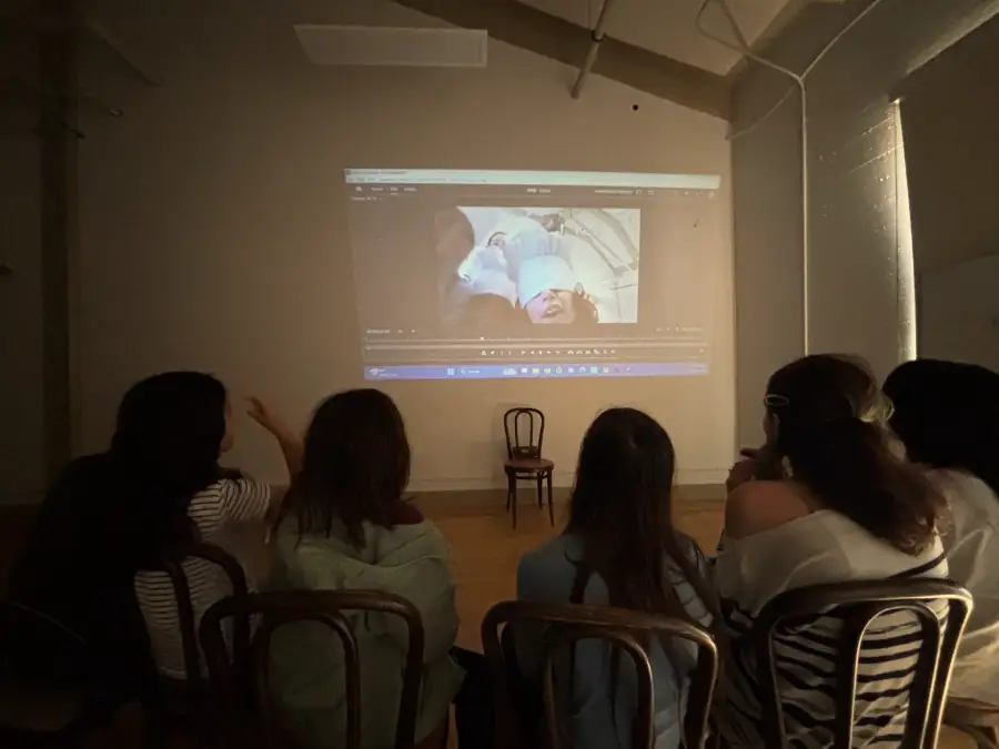 Campers watching their edit projected on the studio wall