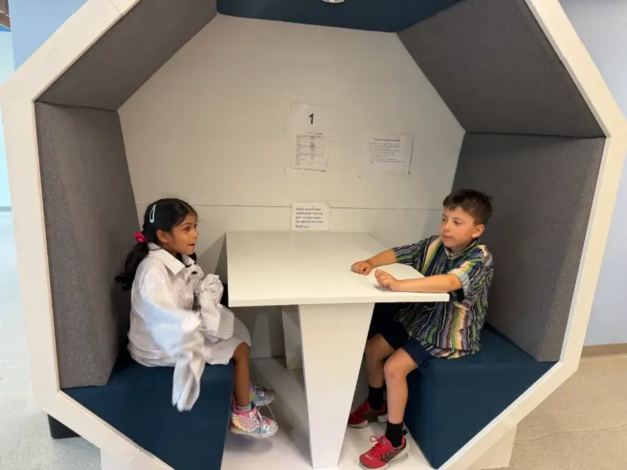 Two campers running lines in a quiet corner of the building